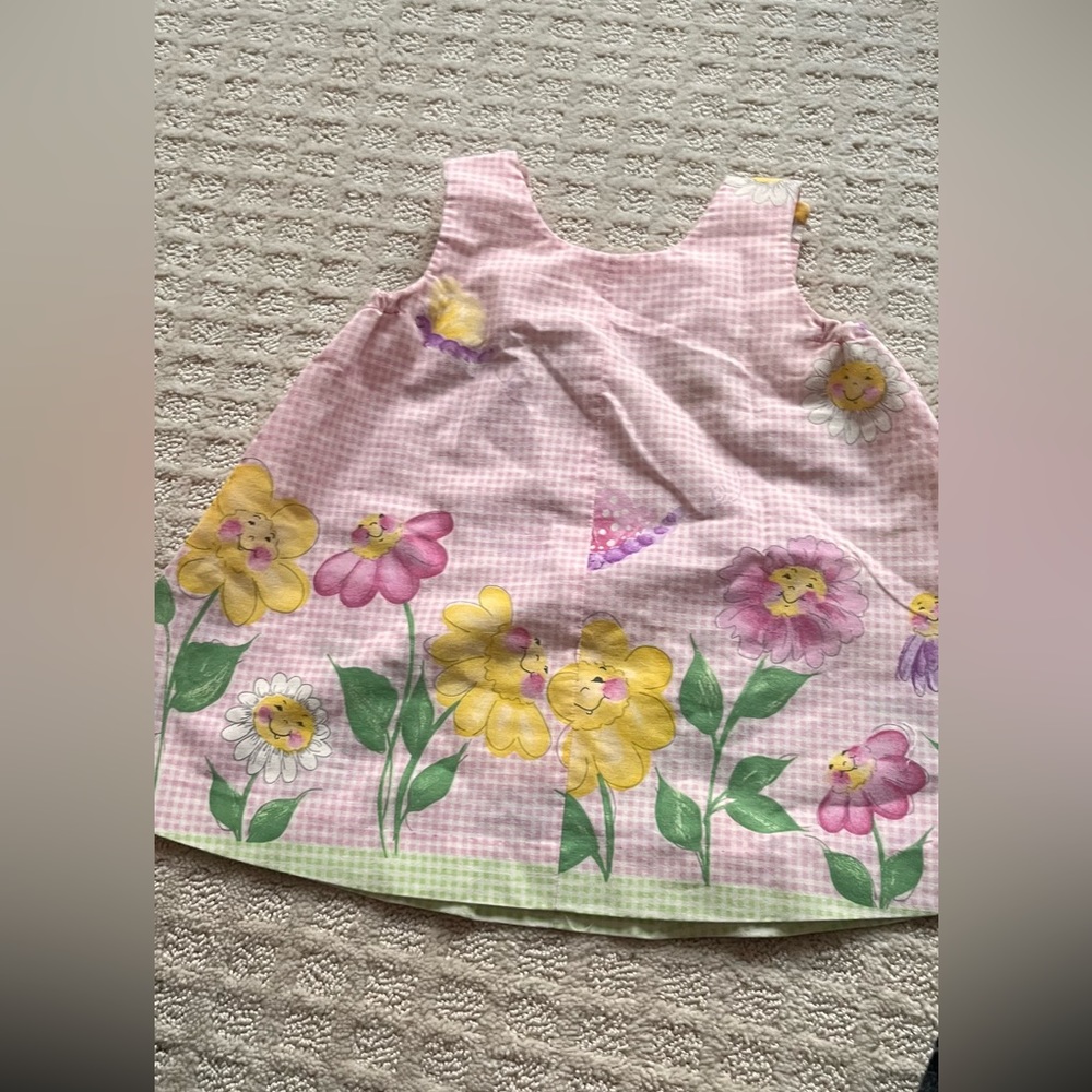 And made dress with frog buttons and flowers
